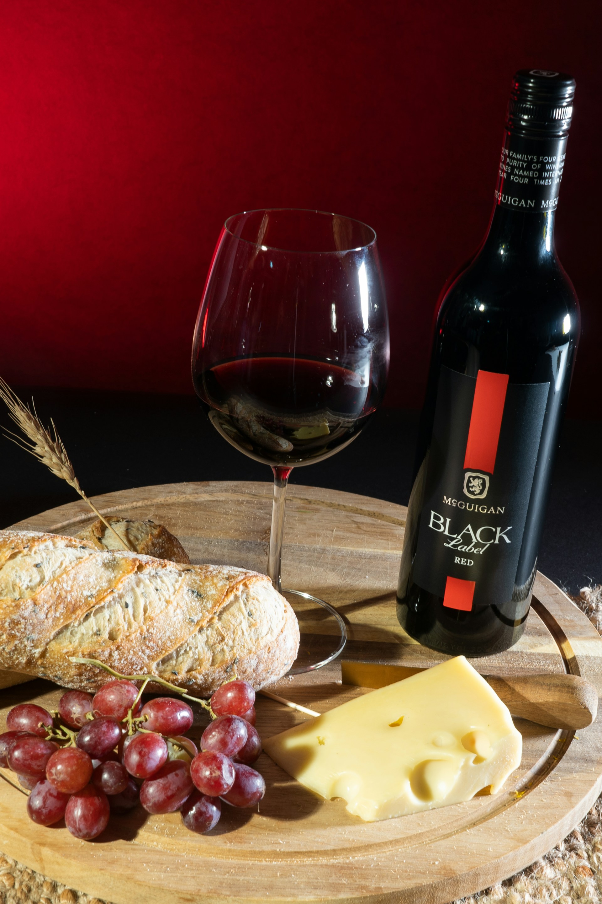 a wine bottle next to a plate of food and a glass of wine