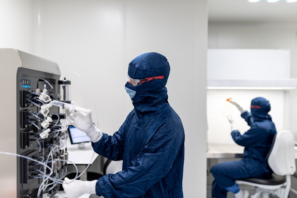 a few people in protective gear working on a computer
