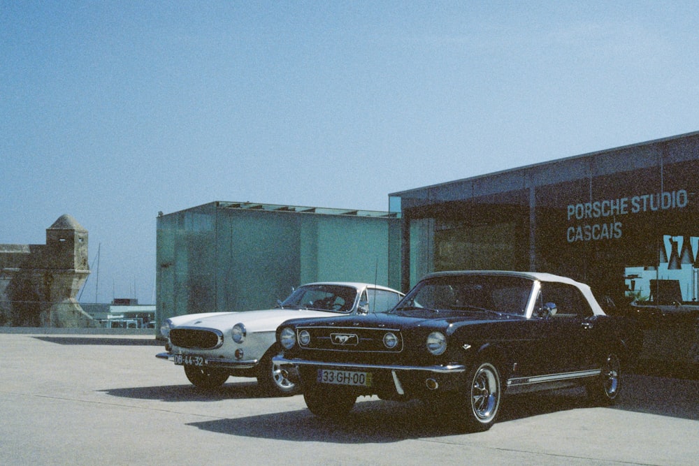 a couple of cars parked in front of a building