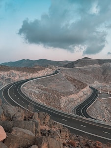 a road with a rocky hillside