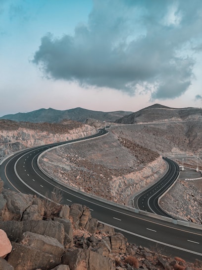 a road with a rocky hillside