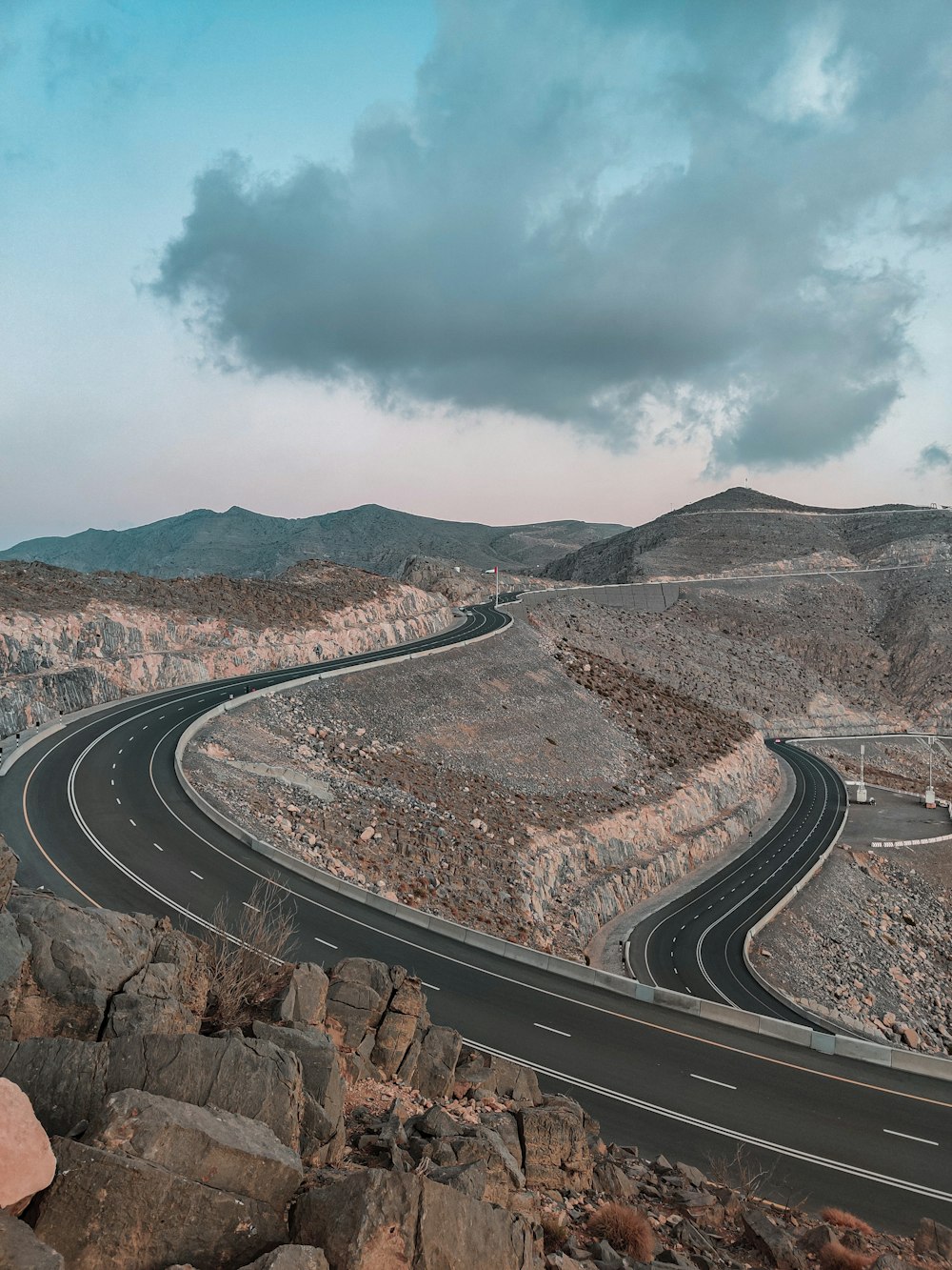 a road with a rocky hillside