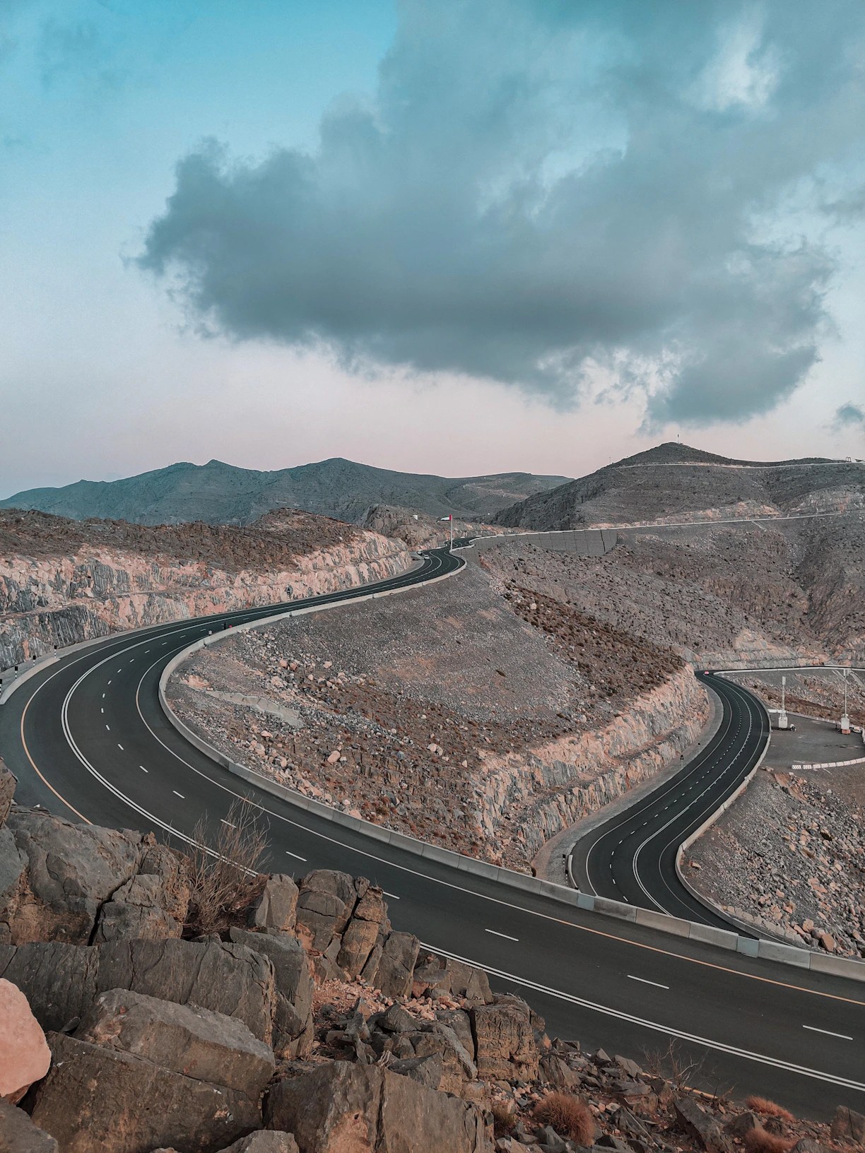 a road with a rocky hillside
