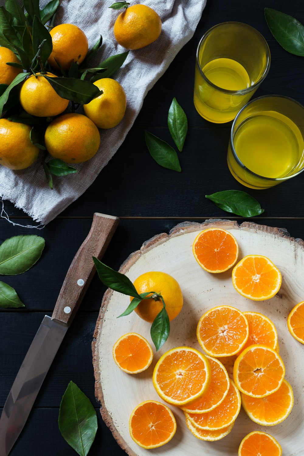 a plate of oranges and a knife