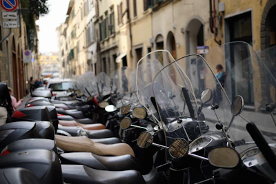 a row of motorcycles parked on the side of a street