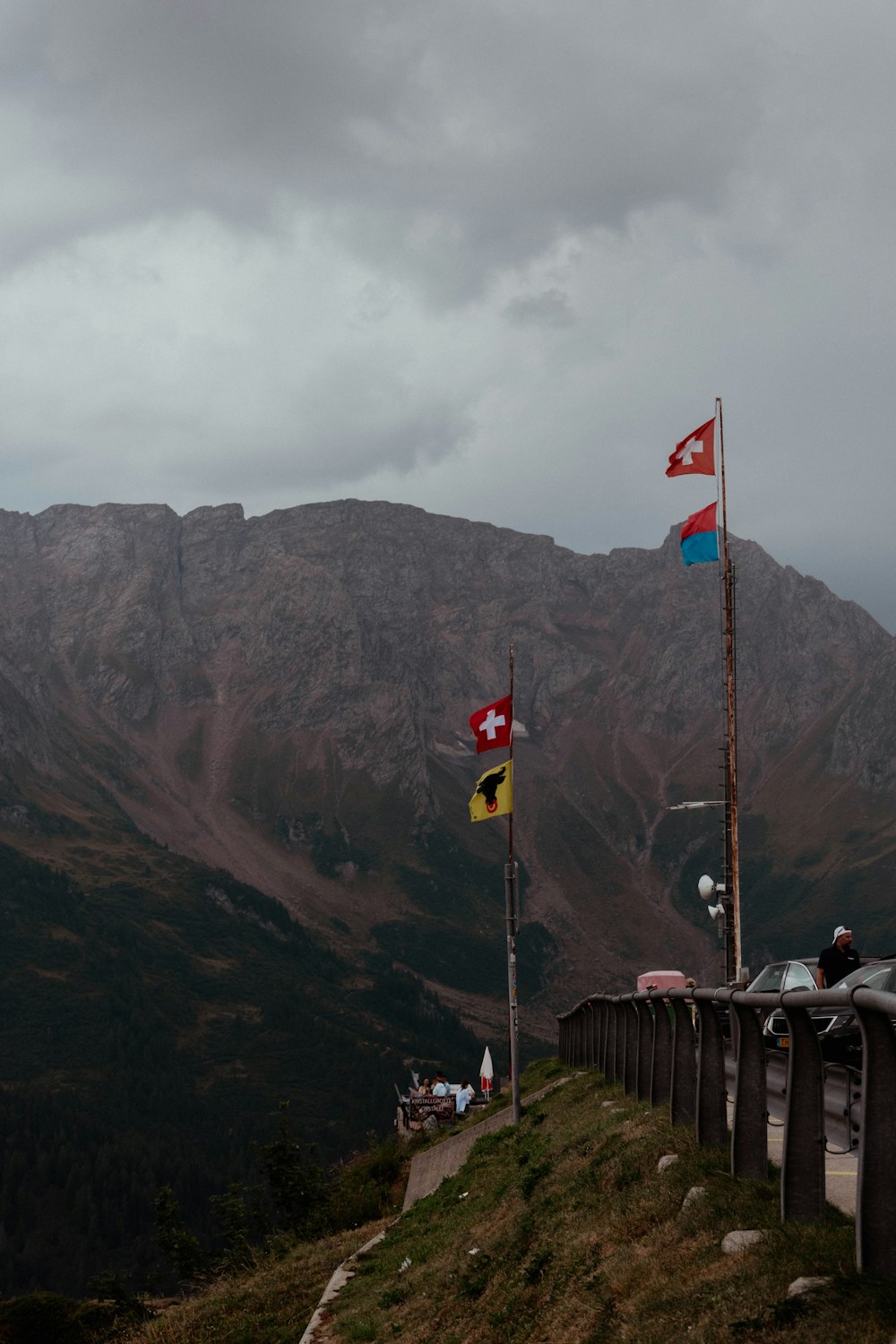 a group of people sitting on a bench in front of a mountain