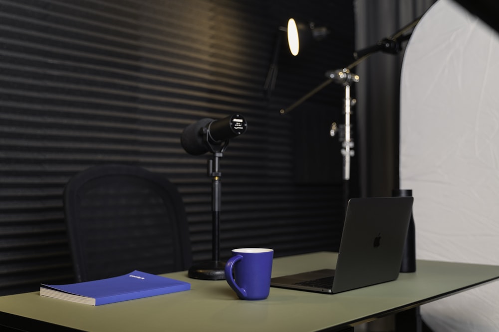 a laptop and a cup on a table