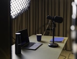 Interview setup with microphones and notes on a table