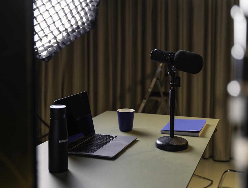 a laptop and a coffee cup on a desk