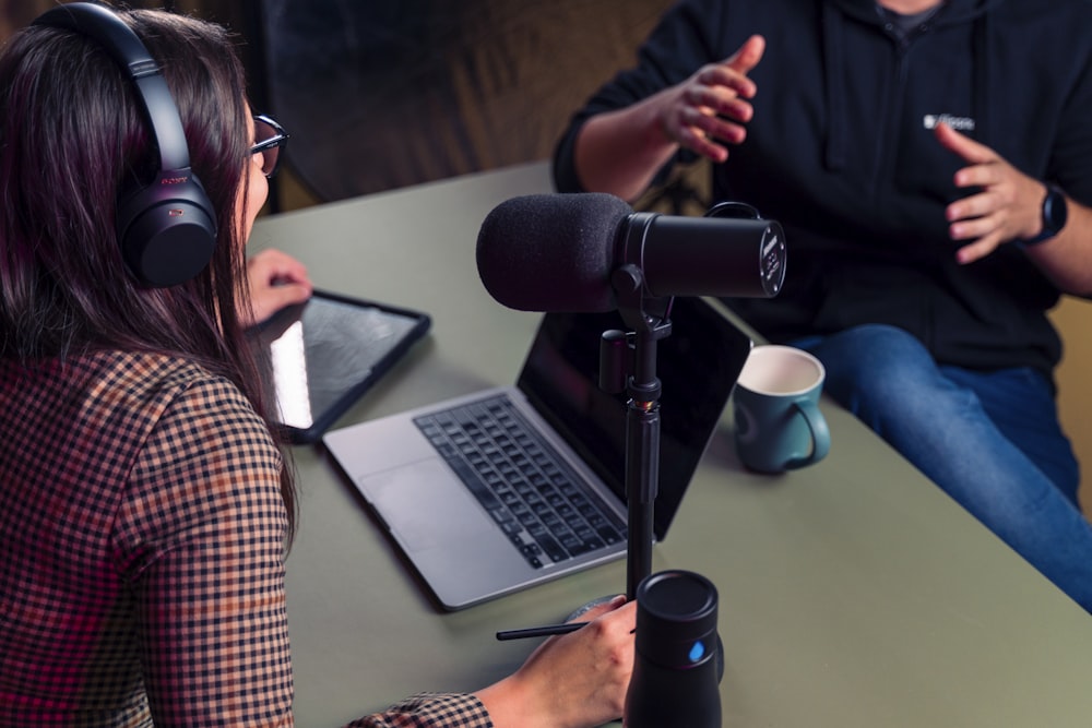 a person with headphones on using a laptop