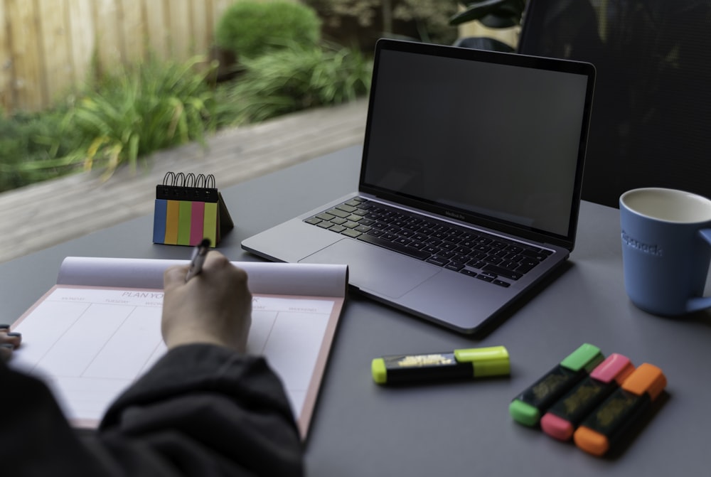 a person's hand on a laptop