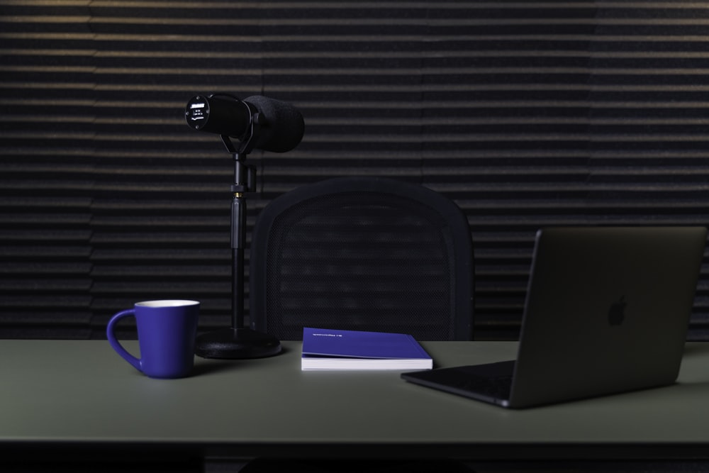 a laptop and a lamp on a table