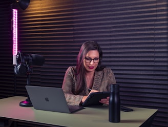 a woman sitting at a desk with a laptop