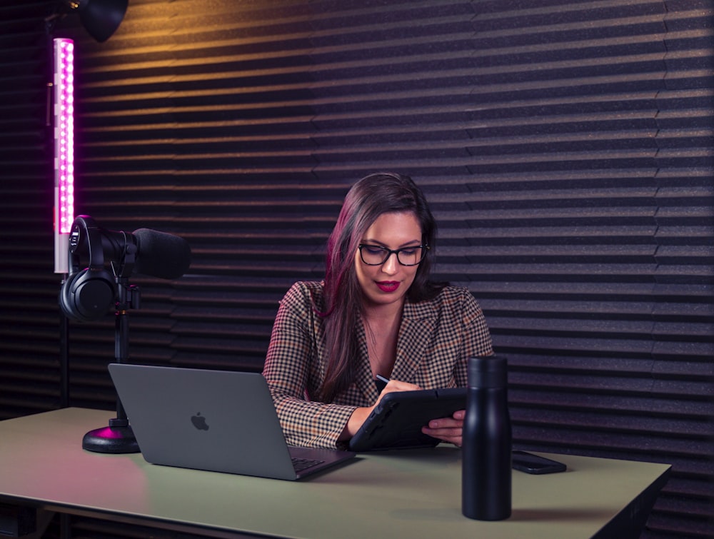 a woman sitting at a desk with a laptop