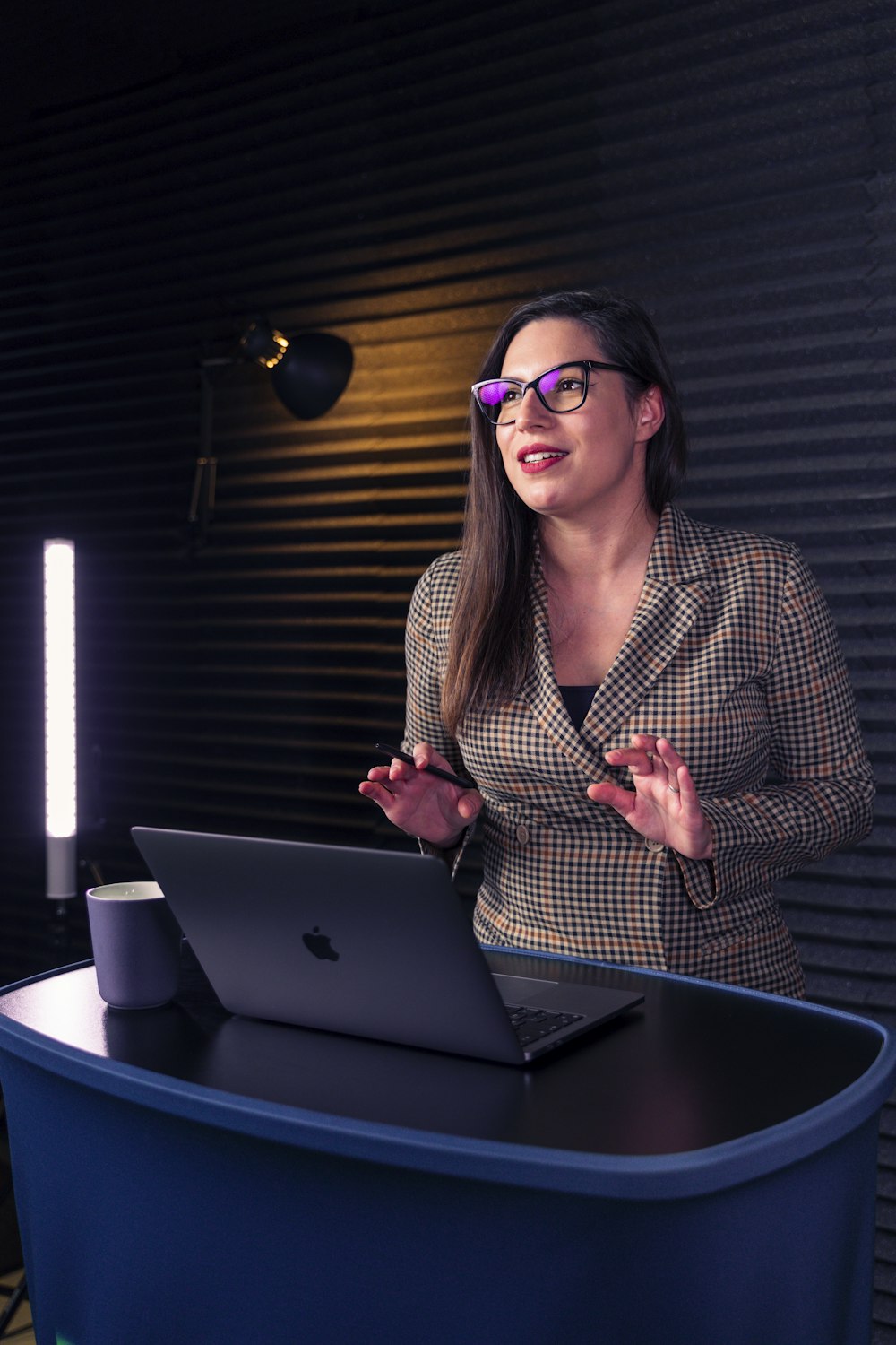 a woman sitting at a table with a laptop