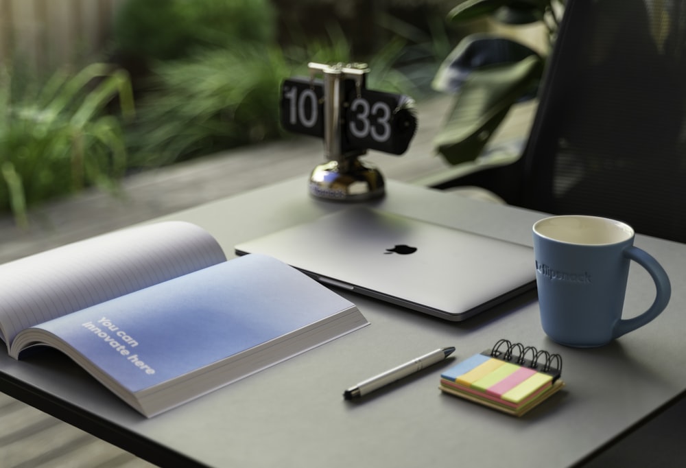 a desk with a laptop and a cup of coffee