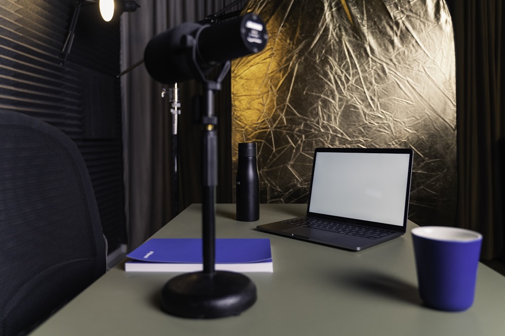 a laptop and a lamp on a table
