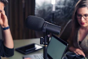 A group of diverse guests sharing stories during a lively podcast recording session.