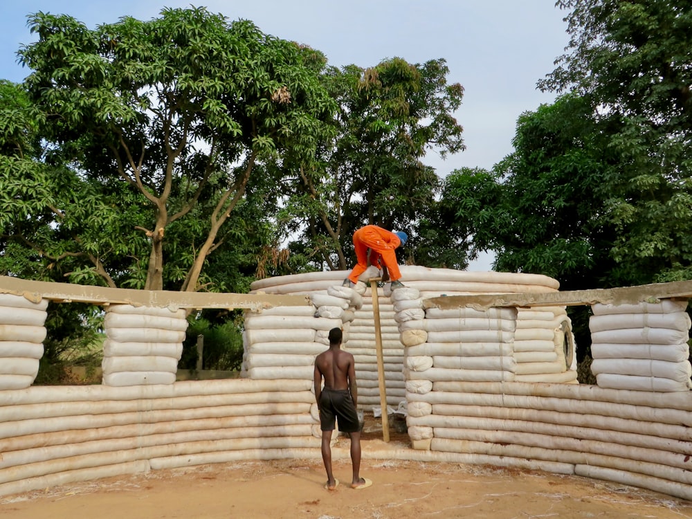 a man standing on a pile of bricks