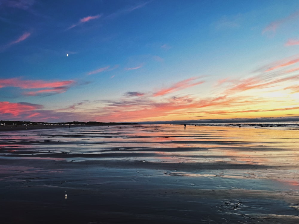 a body of water with a sunset