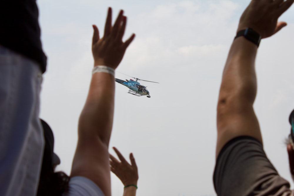 a group of people watching a helicopter