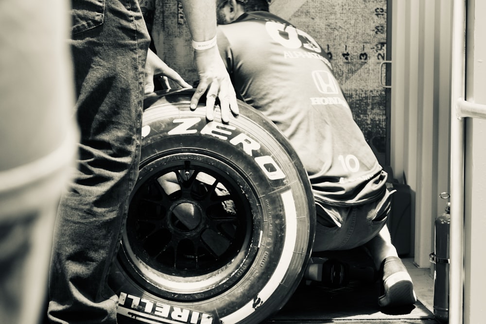 a person holding a tire