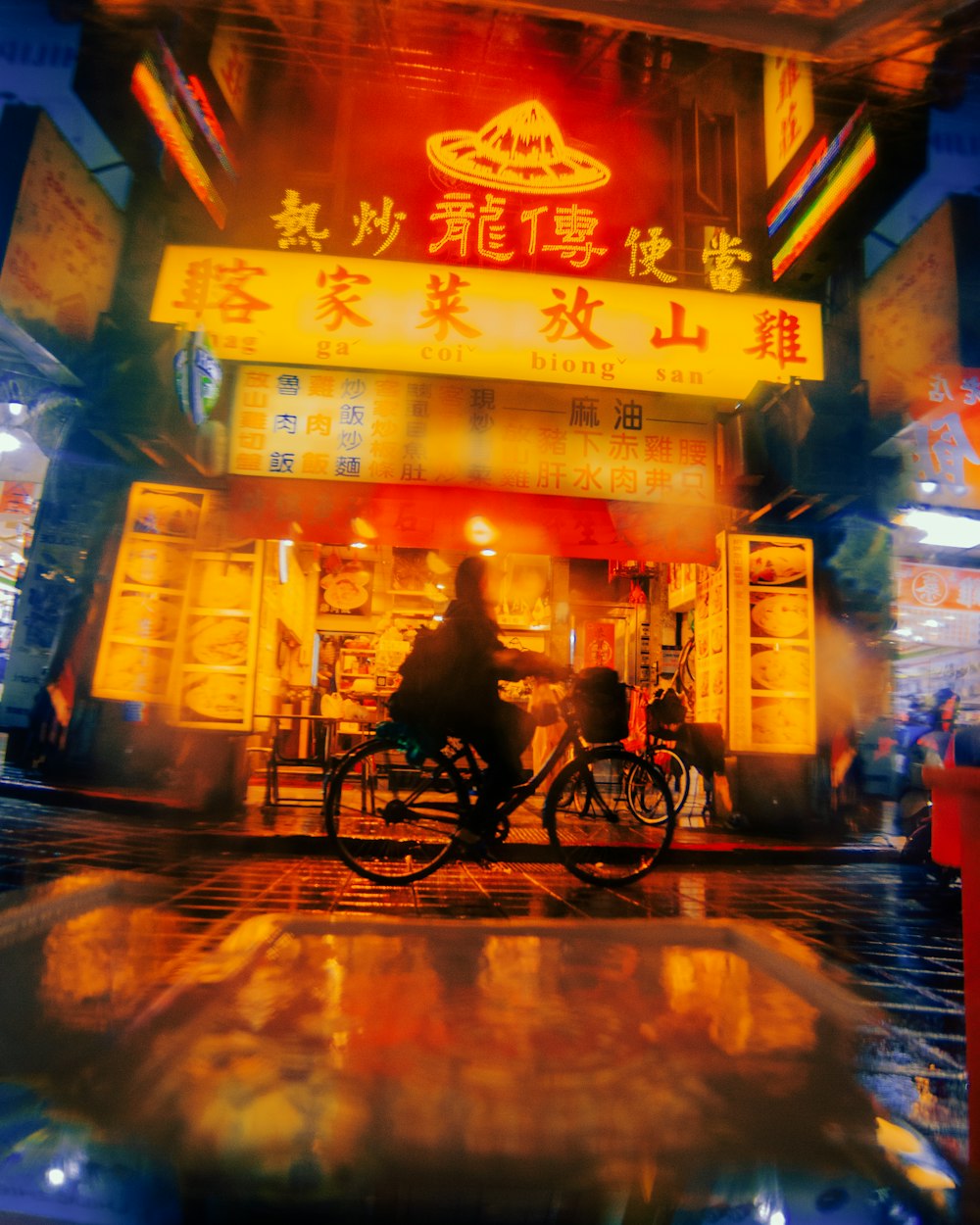 a person riding a bicycle in front of a store