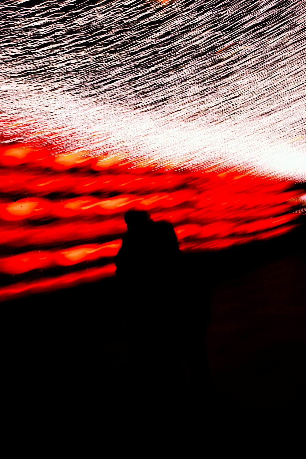 a person standing in front of a large fire