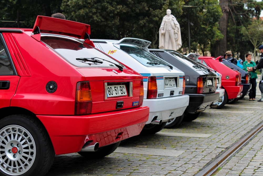 a group of cars parked on a brick road