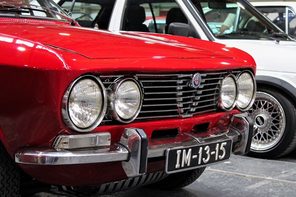 a red car parked next to another car