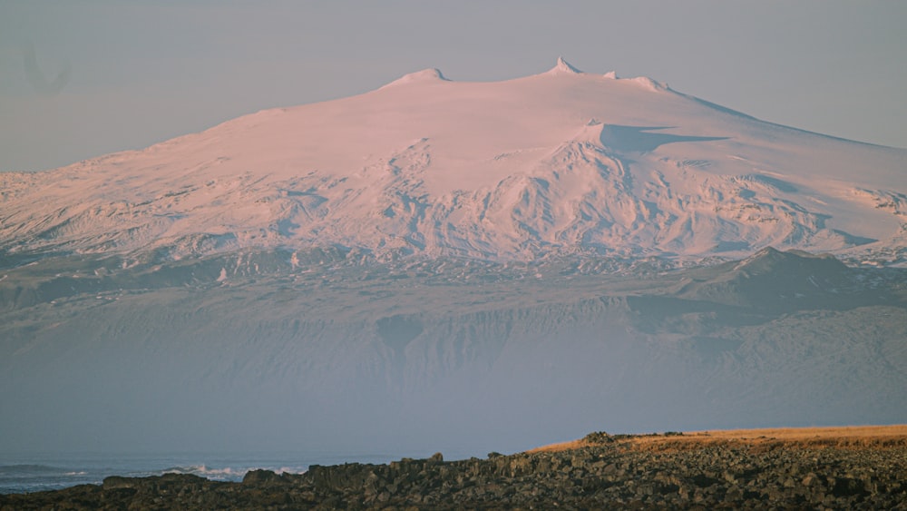 a mountain with a body of water below