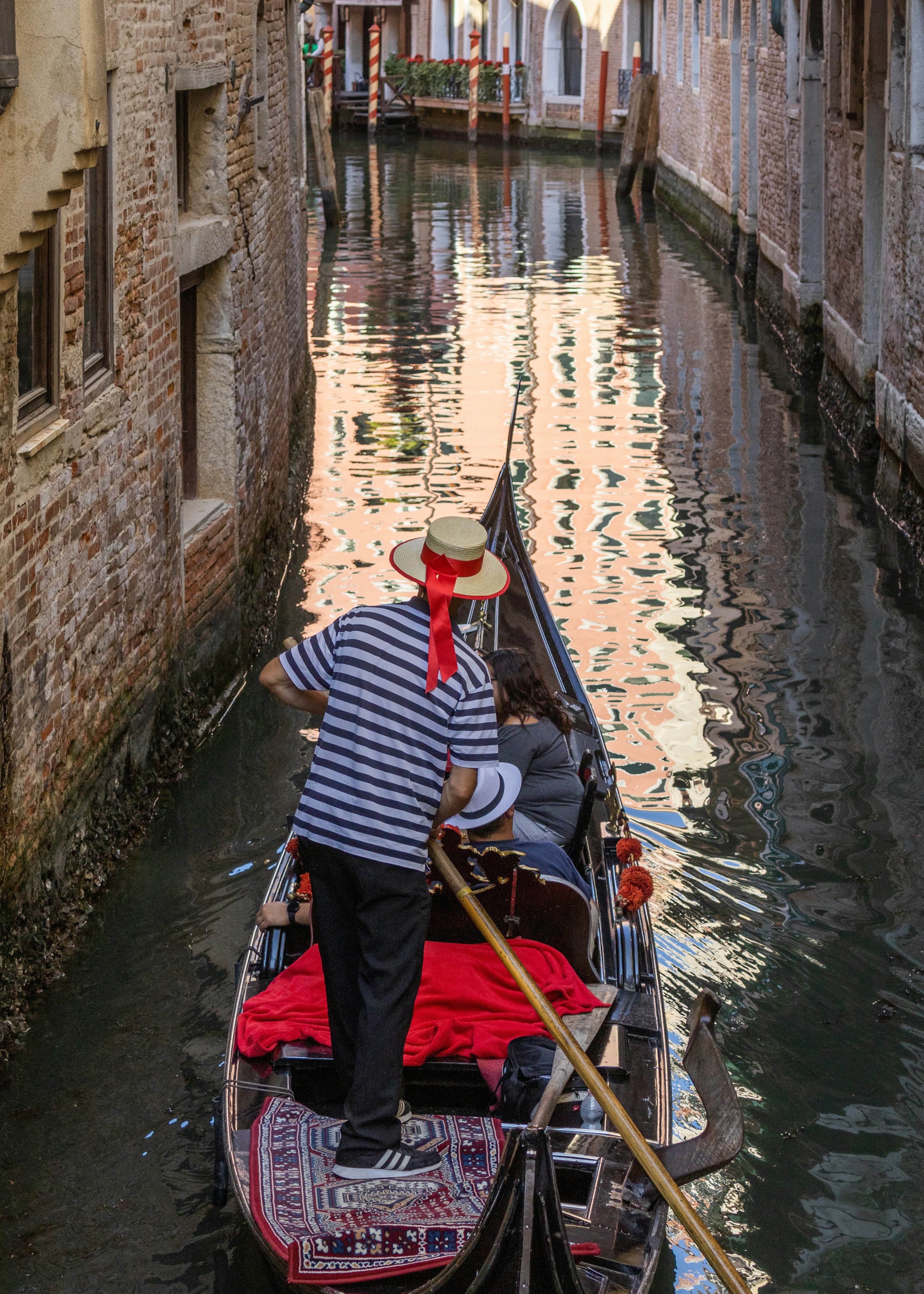 a man and a woman on a boat in a canal