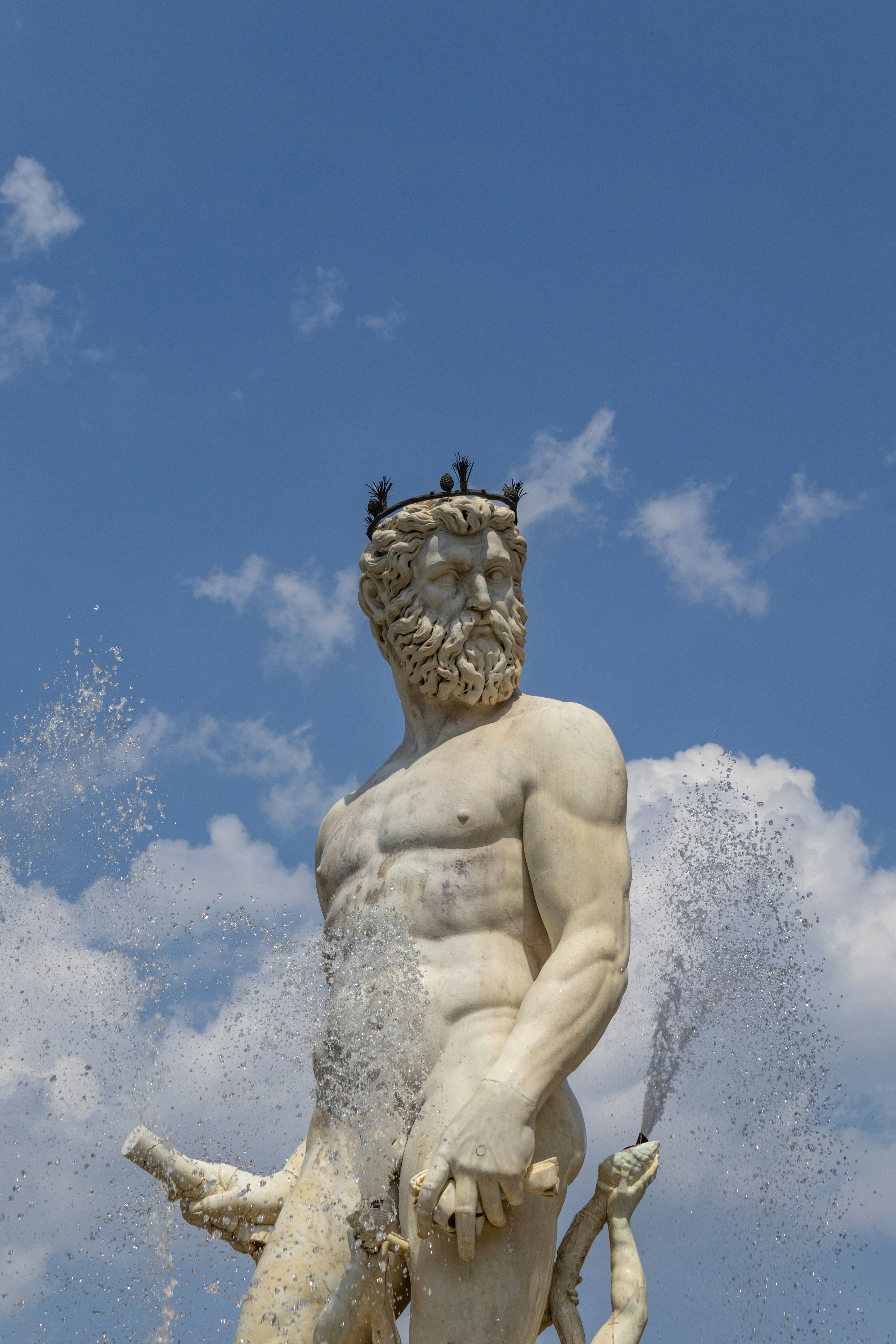 a statue of a person with a beard and a crown