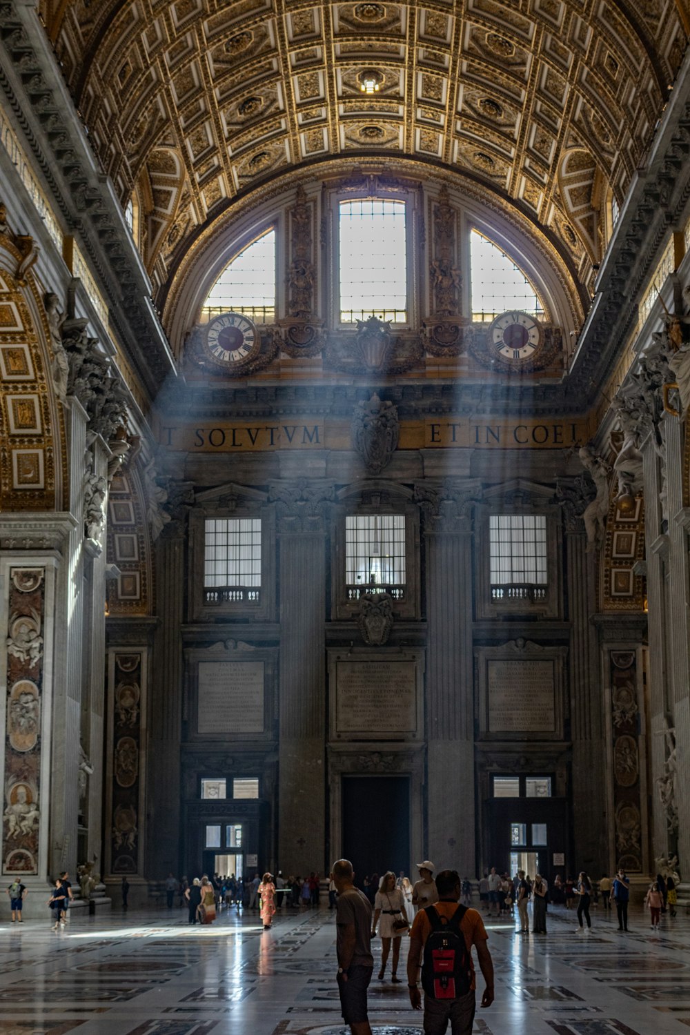 a large ornate building with people walking around