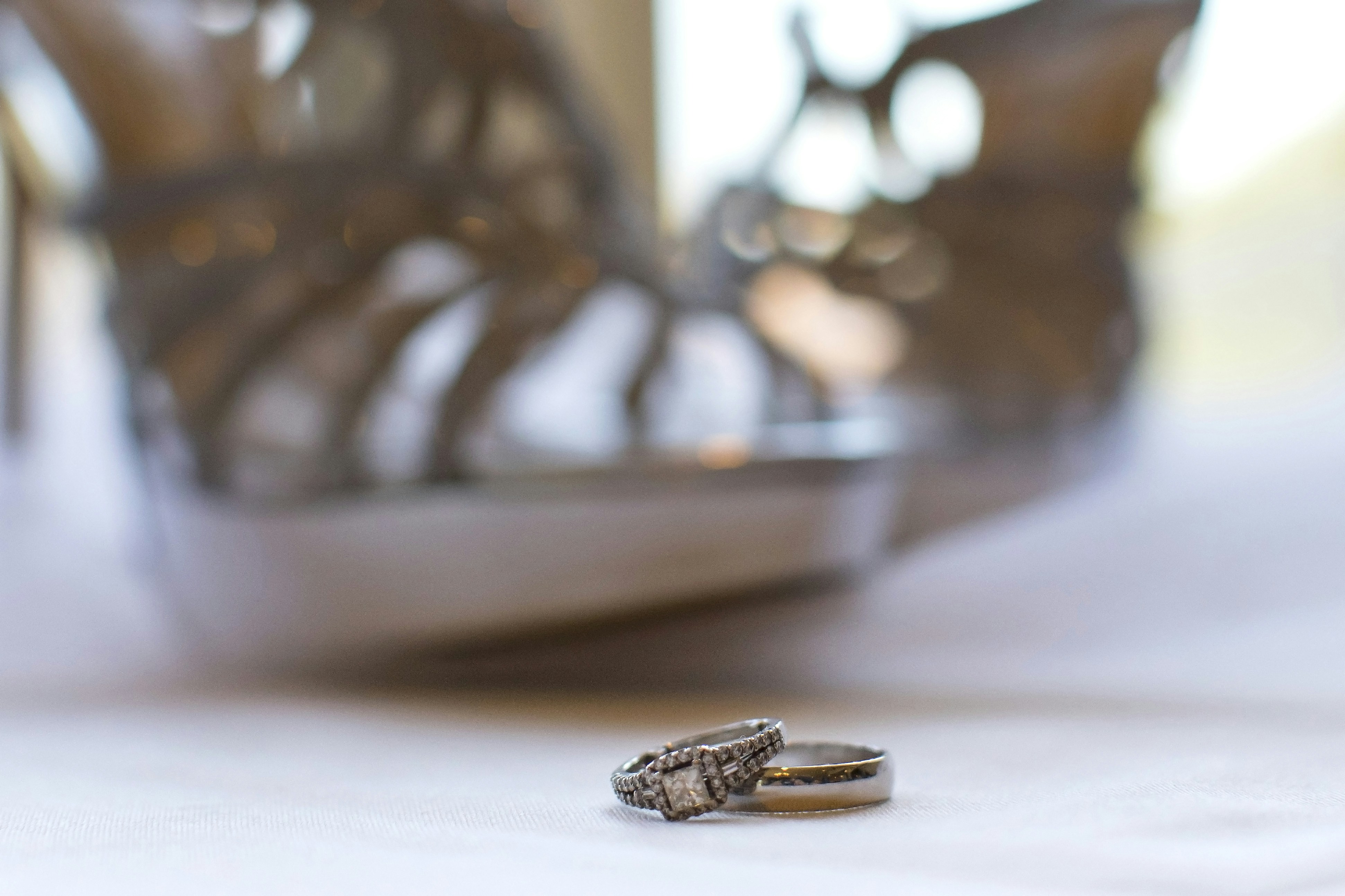 Diamond rings on white surface, bright clean photography