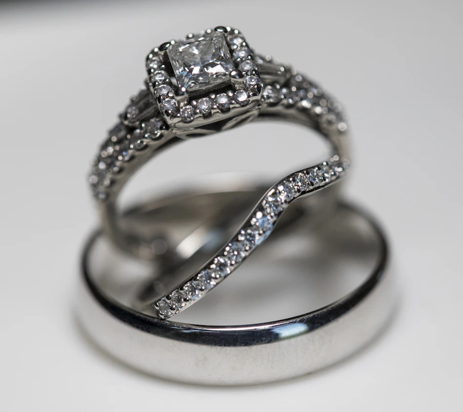 A single diamond ring photographed on a clear white background