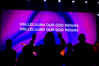 a group of people in front of a screen with text