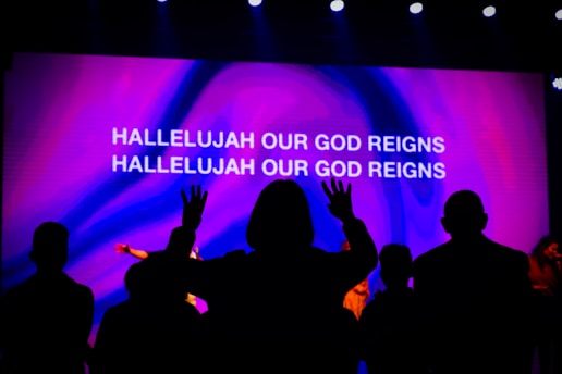 a group of people in front of a screen with text