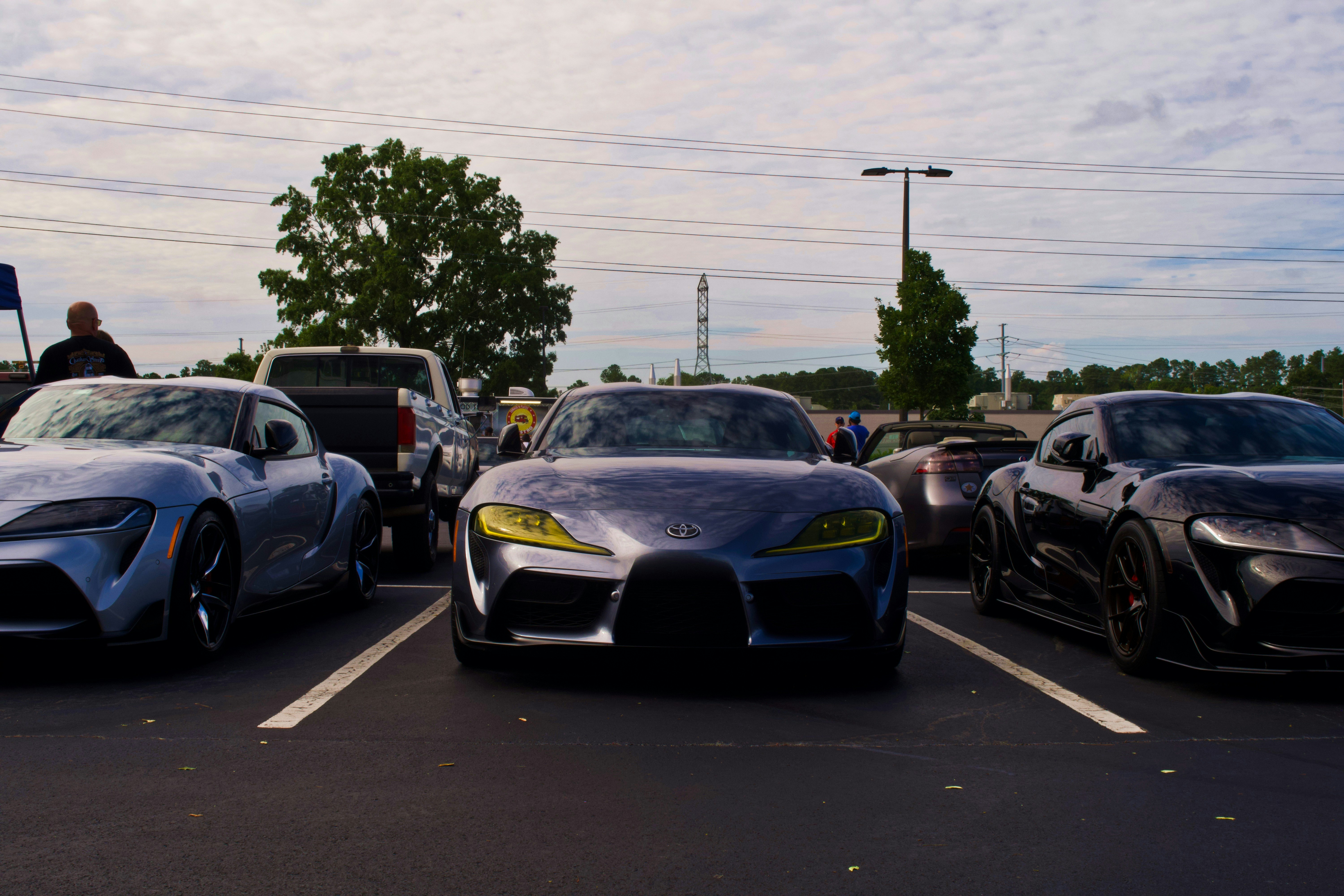 Supra's lined up at a car meet