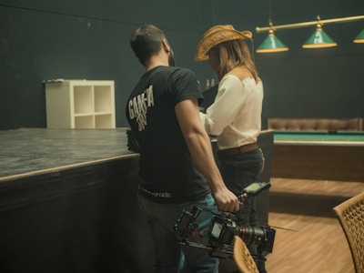 a man and woman looking at a camera