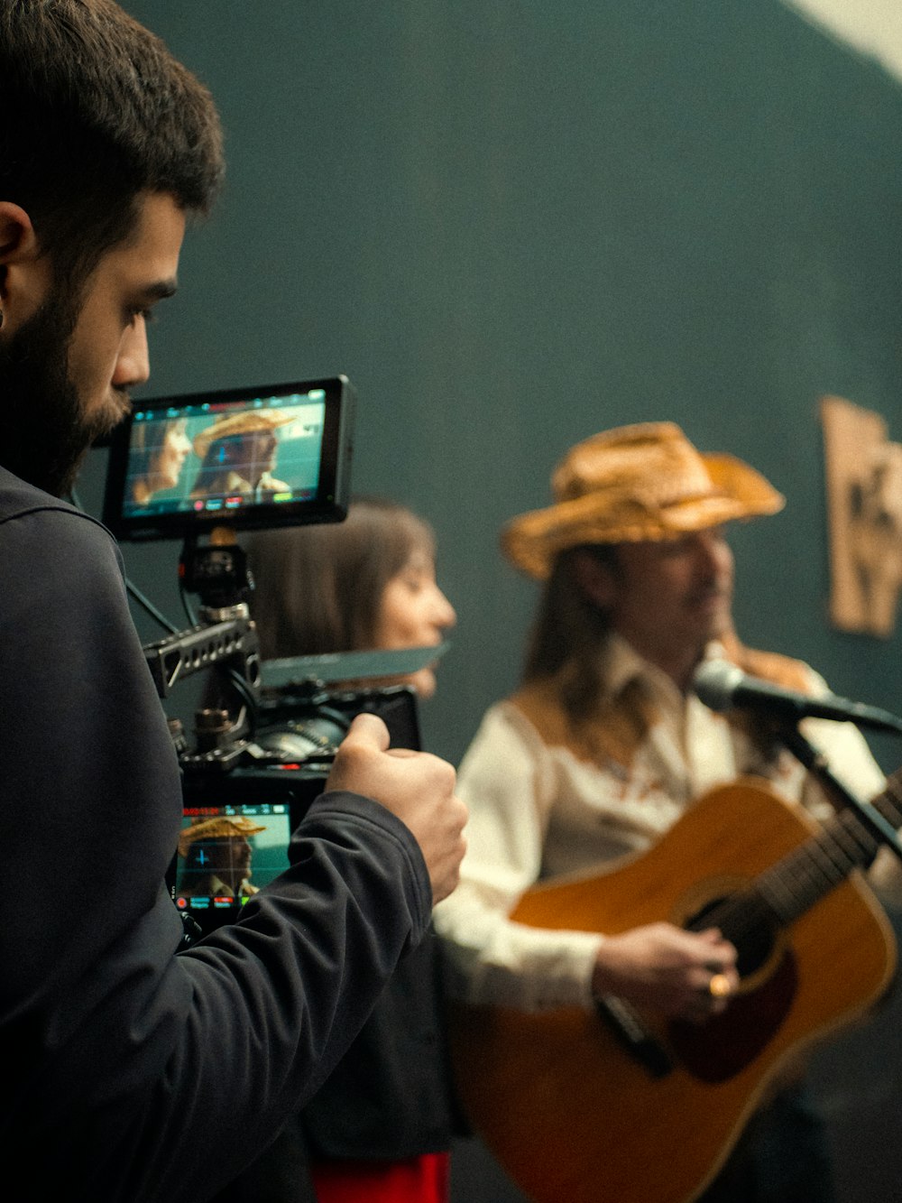 a man playing guitar next to a woman playing a guitar