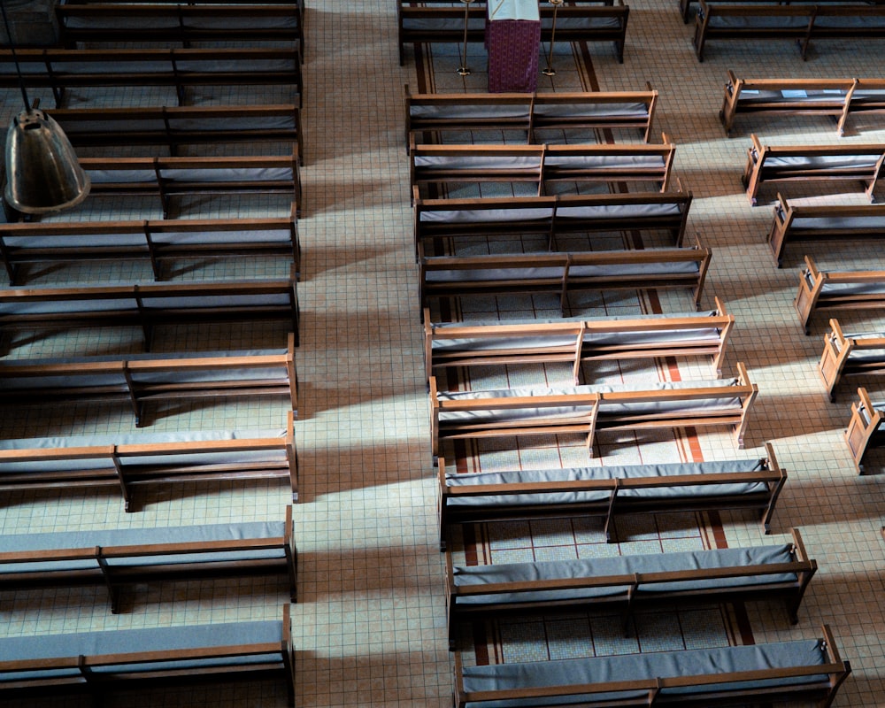 a large room with rows of wooden benches