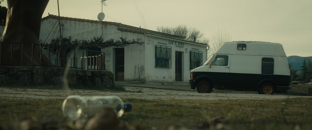 a white van parked in front of a house