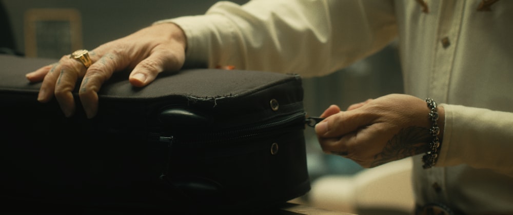 a close-up of hands holding a briefcase
