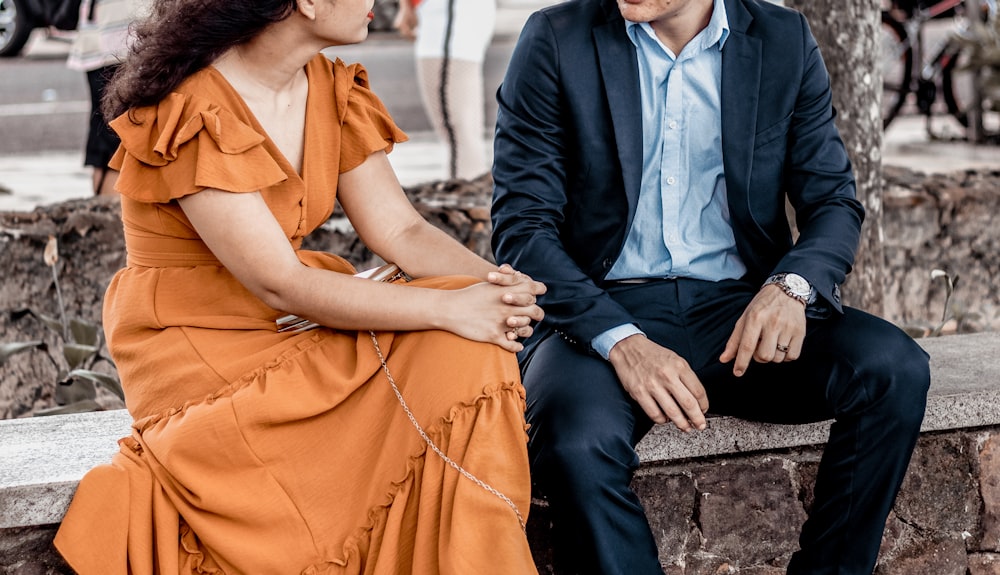 a man and woman sitting on a bench