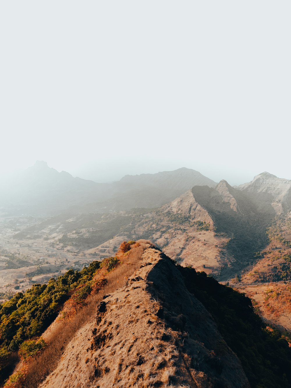 a rocky mountain with a valley below