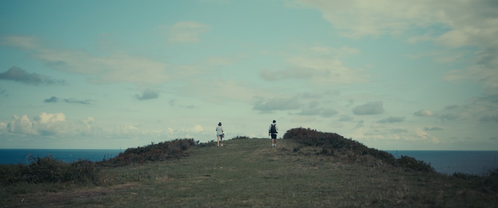 a group of people walking on a hill