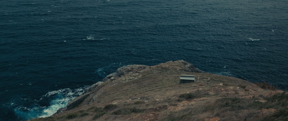 a building on a hill by the water