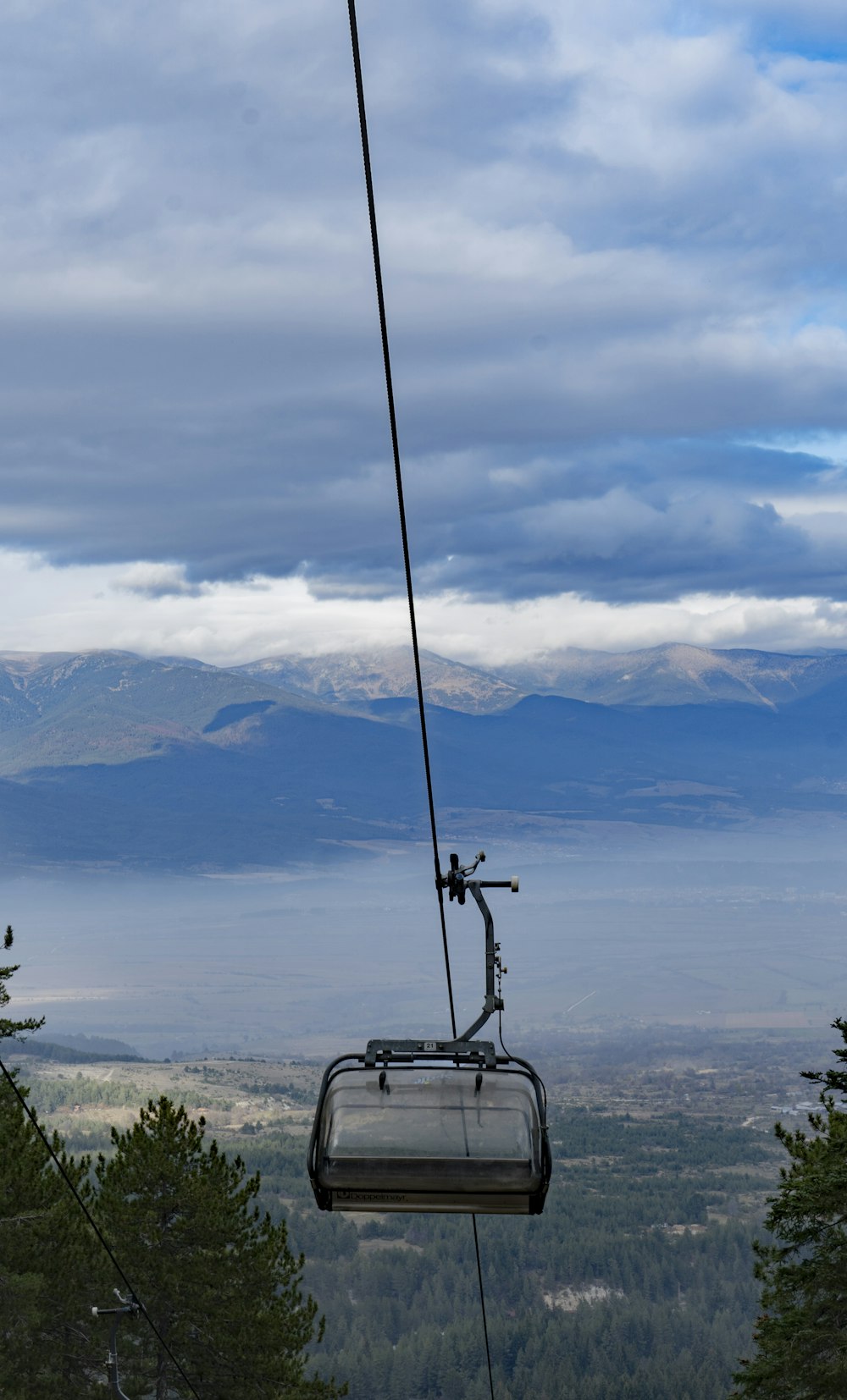 a chair suspended from a cable