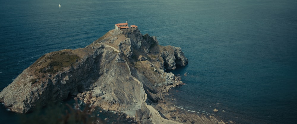a small house on a rocky cliff